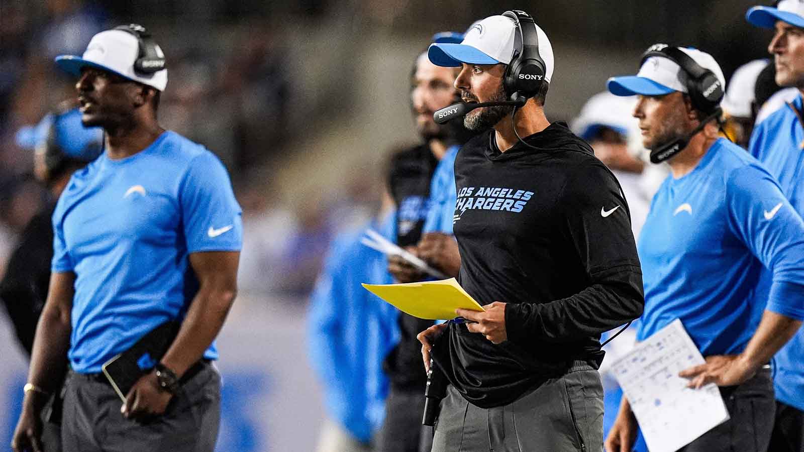 LA Chargers defensive coordinator Jesse Minter, center right, watches a play against Detroit Lions during the first half of the Hall of Fame Game at Tom Benson Hall of Fame Stadium in Canton, Ohio on Thursday, July 31, 2025.