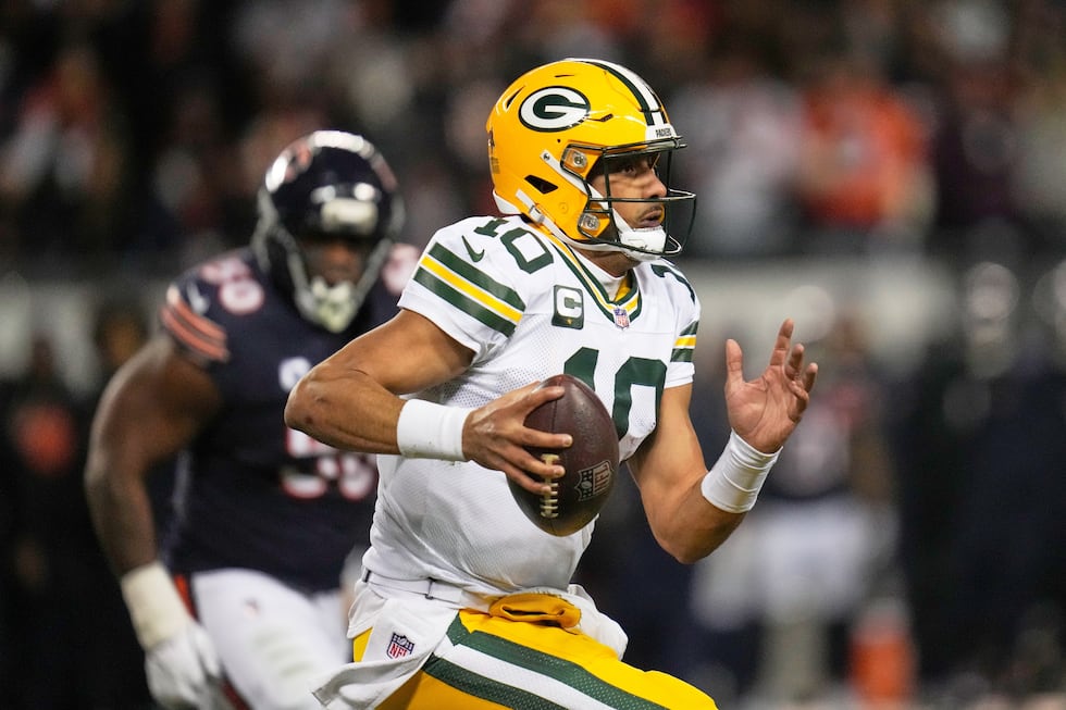 Green Bay Packers' Jordan Love scrambles during the first half of an NFL football game against...