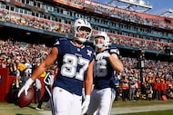 Dallas Cowboys tight end Jake Ferguson (87) celebrates with Luke Schoonmaker (86) after...