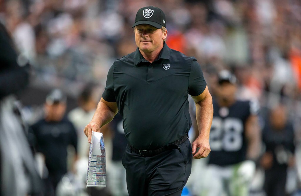 Then-Raiders head coach Jon Gruden runs off the field for halftime during an NFL football game against the Chicago Bears on Oct. 10, 2021, at Allegiant Stadium in Las Vegas. 