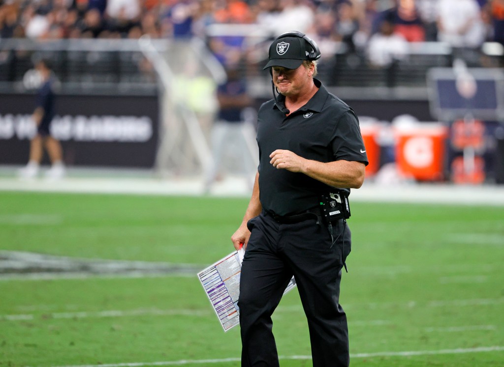 Head coach Jon Gruden of the Las Vegas Raiders walks off the field after checking on an injured player during a game against the Chicago Bears at Allegiant Stadium on October 10, 2021 in Las Vegas, Nevada.