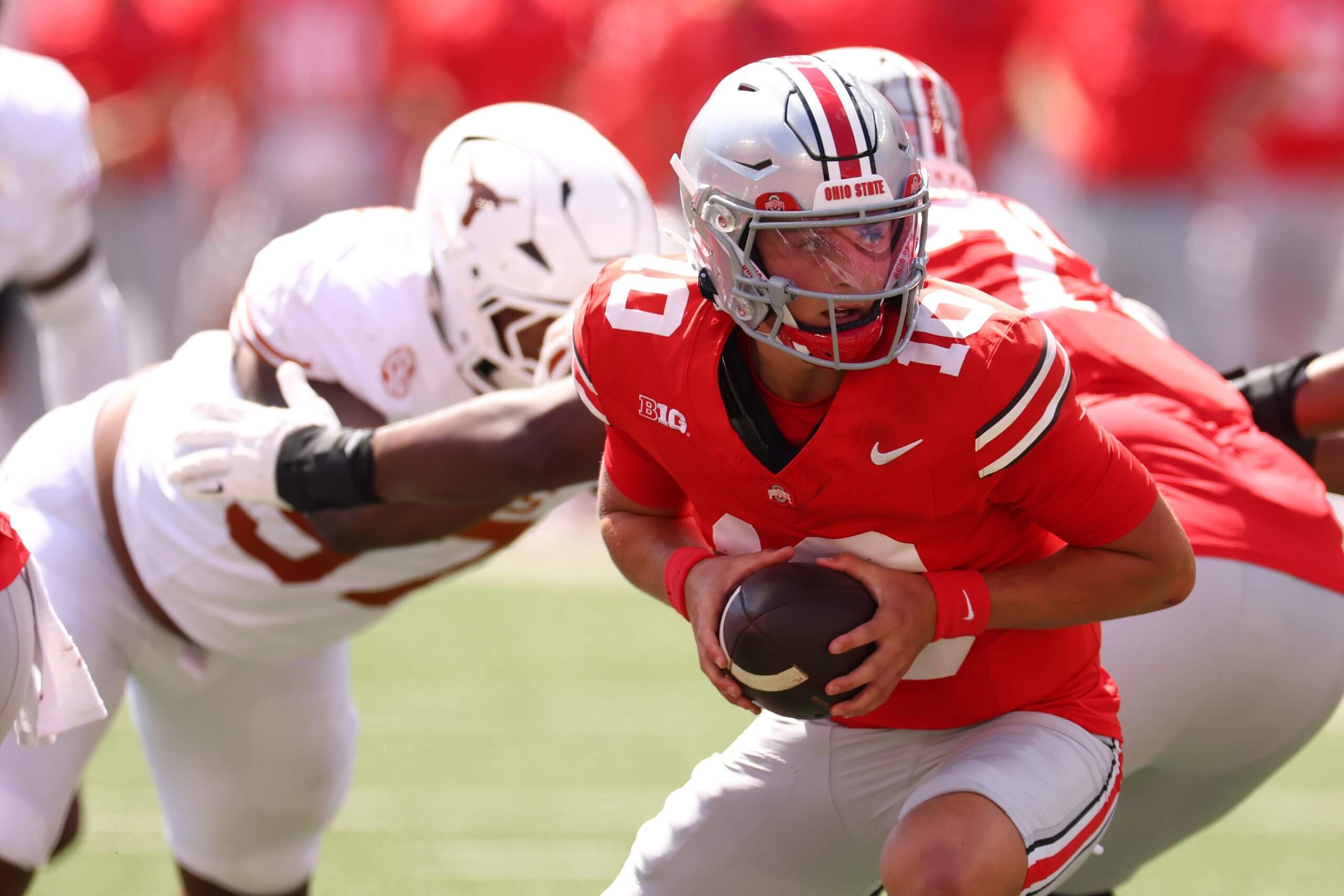 Ohio State quarterback Julian Sayin turns to hand the ball off after a snap against Texas.