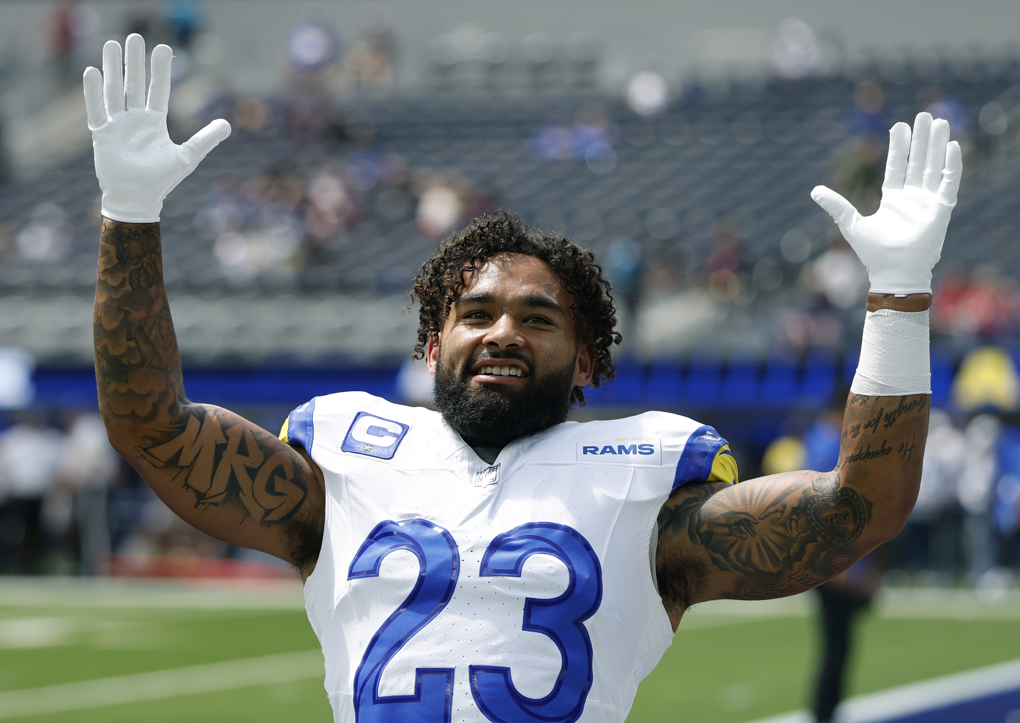 Rams running back Kyren Williams smiles while warming up before...