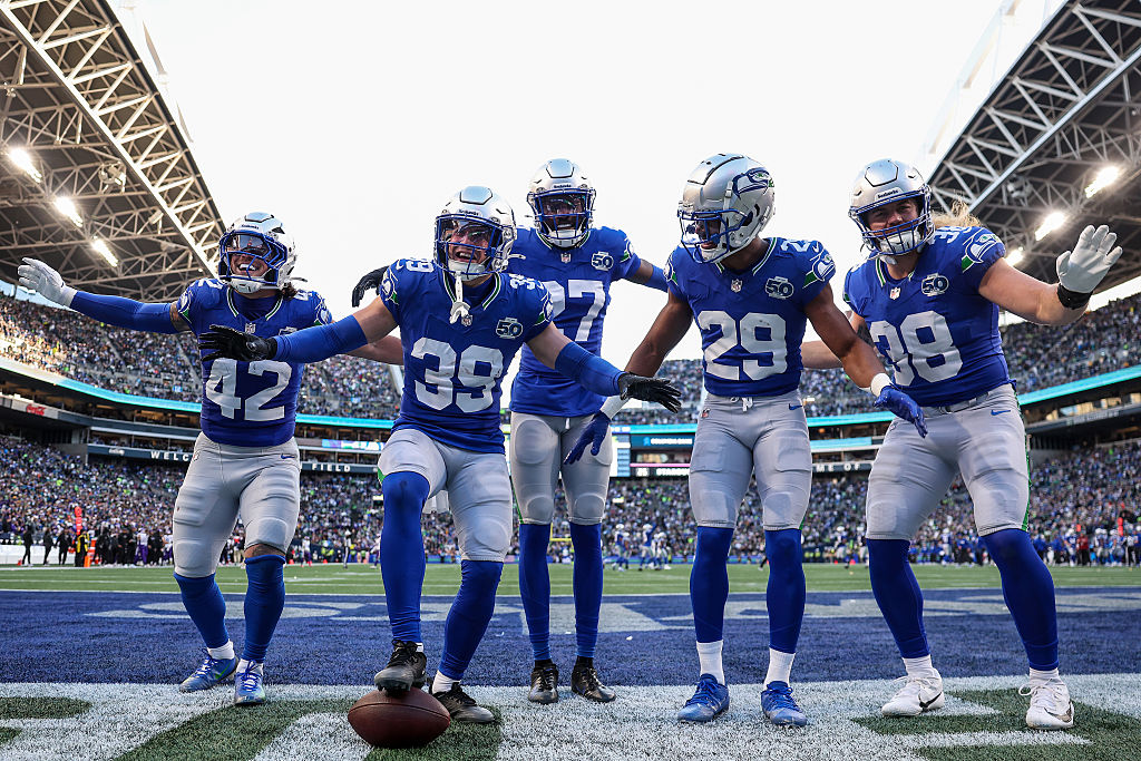 SEATTLE, WASHINGTON - NOVEMBER 30: Ty Okada #39 of the Seattle Seahawks celebrates with members of the defense after his fumble recovery against the Minnesota Vikings in the third quarter of a game at Lumen Field on November 30, 2025 in Seattle, Washington. (Photo by Steph Chambers/Getty Images)