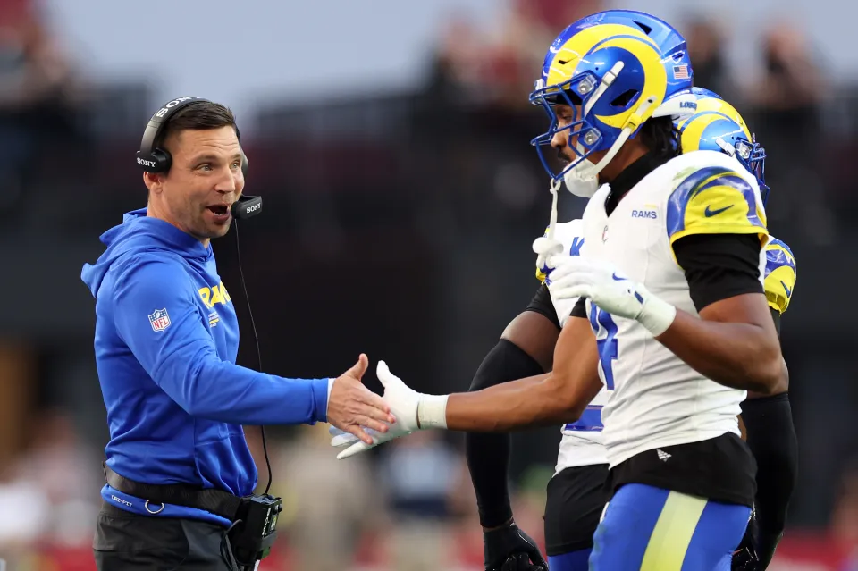 GLENDALE, ARIZONA - DECEMBER 07: Defensive coordinator Chris Shula high fives cornerback Ahkello Witherspoon #4 of the Los Angeles Rams after a defensive stop during the first half against the Arizona Cardinals at State Farm Stadium on December 07, 2025 in Glendale, Arizona. The Rams defeated the Cardinals 45-17. (Photo by Chris Coduto/Getty Images)