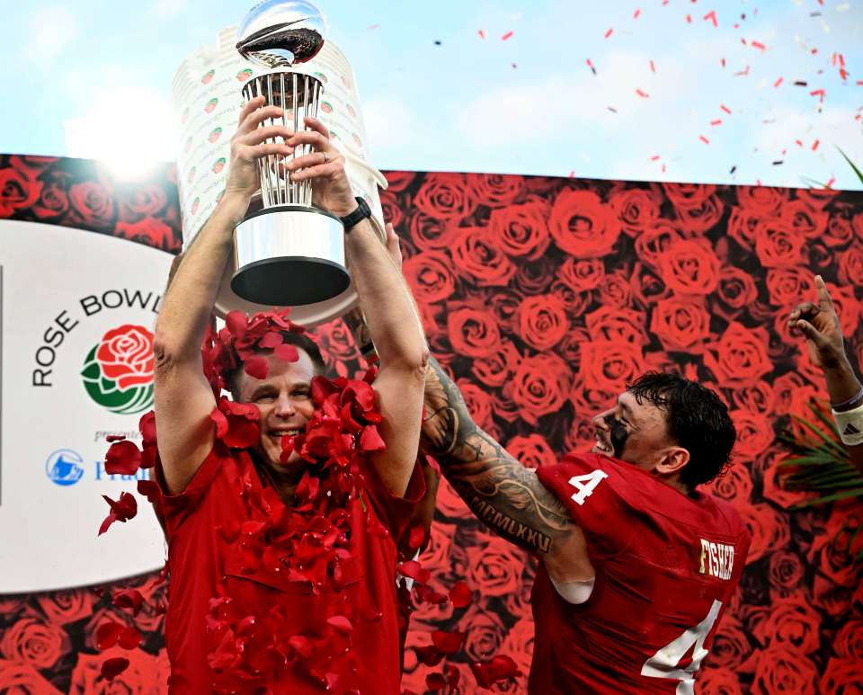 Head coach Curt Cignetti of the Indiana Hoosiers is doused with rose petals by linebacker Aiden Fisher #4 of the Indiana Hoosiers as he holds up the Leishman Trophy after defeating the Alabama Crimson Tide 38-3 to win the 112th Rose Bowl CFP quarterfinal playoff football game in Pasadena on Thursday, January 1, 2026