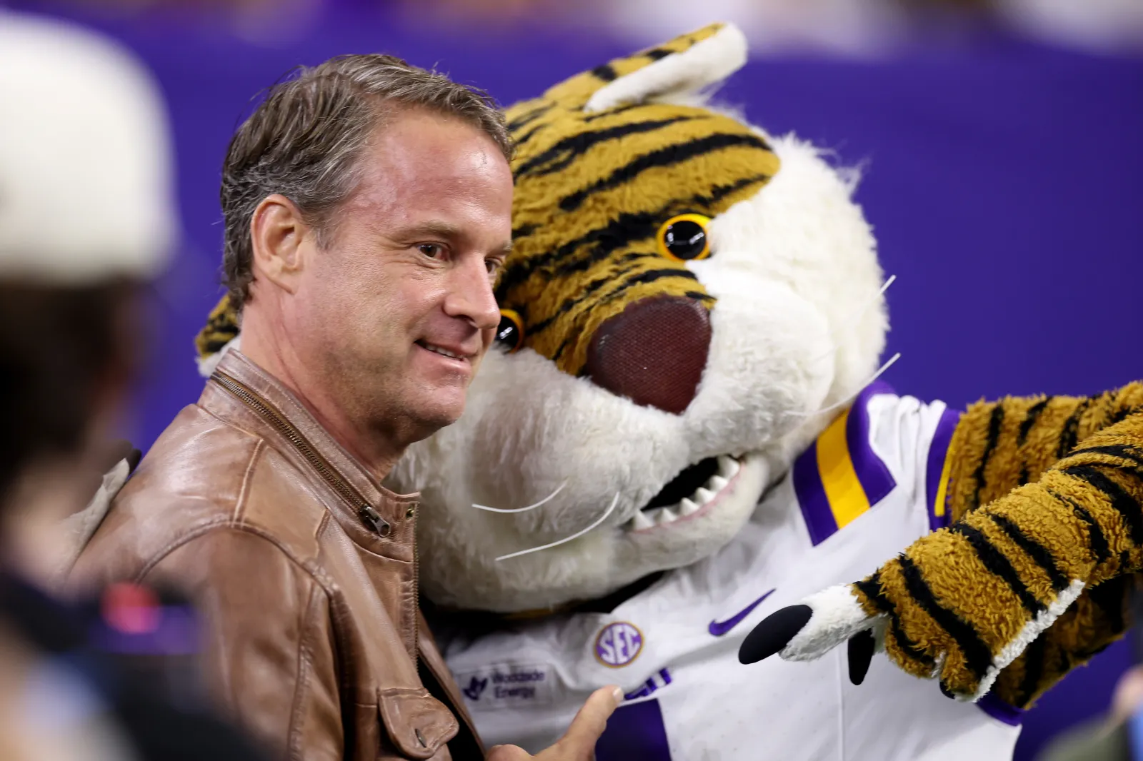 Head coach Lane Kiffin of the Louisiana State Tigers poses with the mascot before the game against the Houston Cougars during the Kinder's Texas Bowl at NRG Stadium on December 27, 2025 in Houston, Texas.
