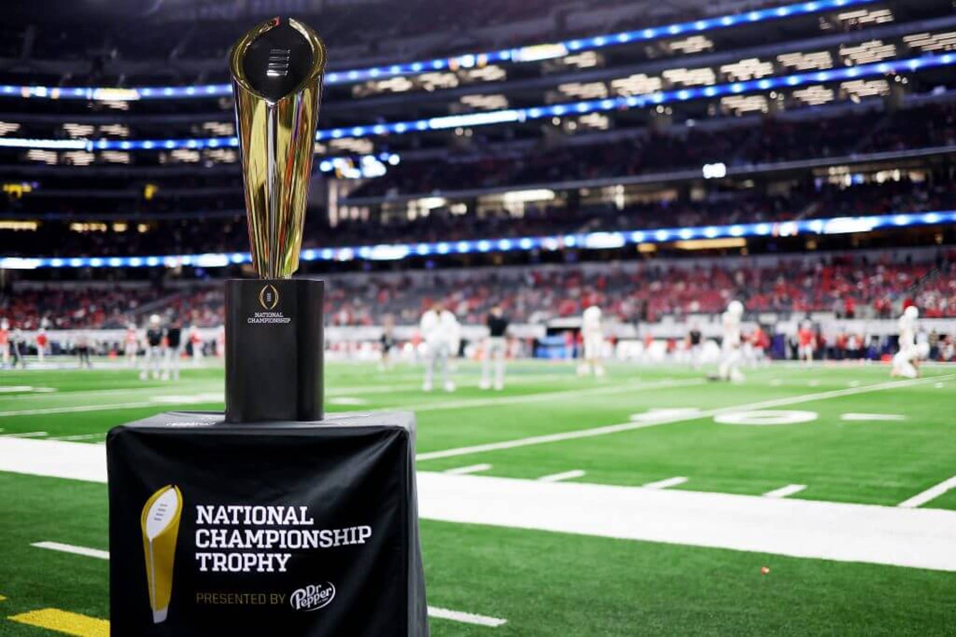 The College Football Playoff national championship trophy sits on the sideline at the Cotton Bowl
