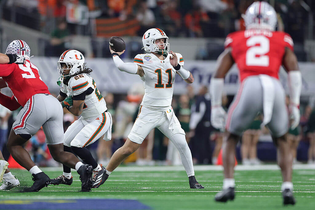 Carson Beck reaches back to pass. 