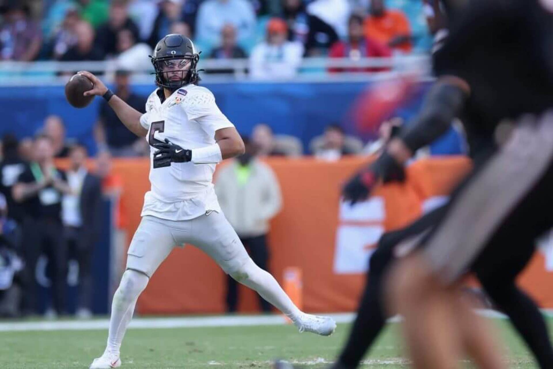 Oregon quarterback Dante Moore throws a pass on the run in the Orange Bowl against Texas Tech.