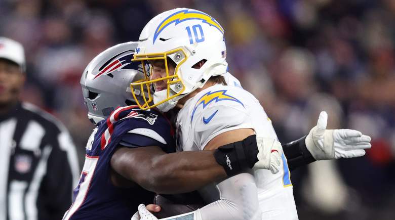 Milton Williams #97 of the New England Patriots tackles Justin Herbert #10 of the Los Angeles Chargers during the fourth quarter of the AFC Wild Card Playoff game at Gillette Stadium on January 11, 2026 in Foxborough, Massachusetts.