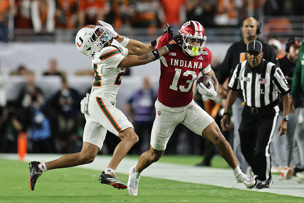 Elijah Sarratt of the Indiana Hoosiers stiff arms Ethan O'Connor of the Miami Hurricanes during the first quarter in the 2026 College Football Playoff National Championship at Hard Rock Stadium on January 19, 2026 in Miami Gardens, Florida.