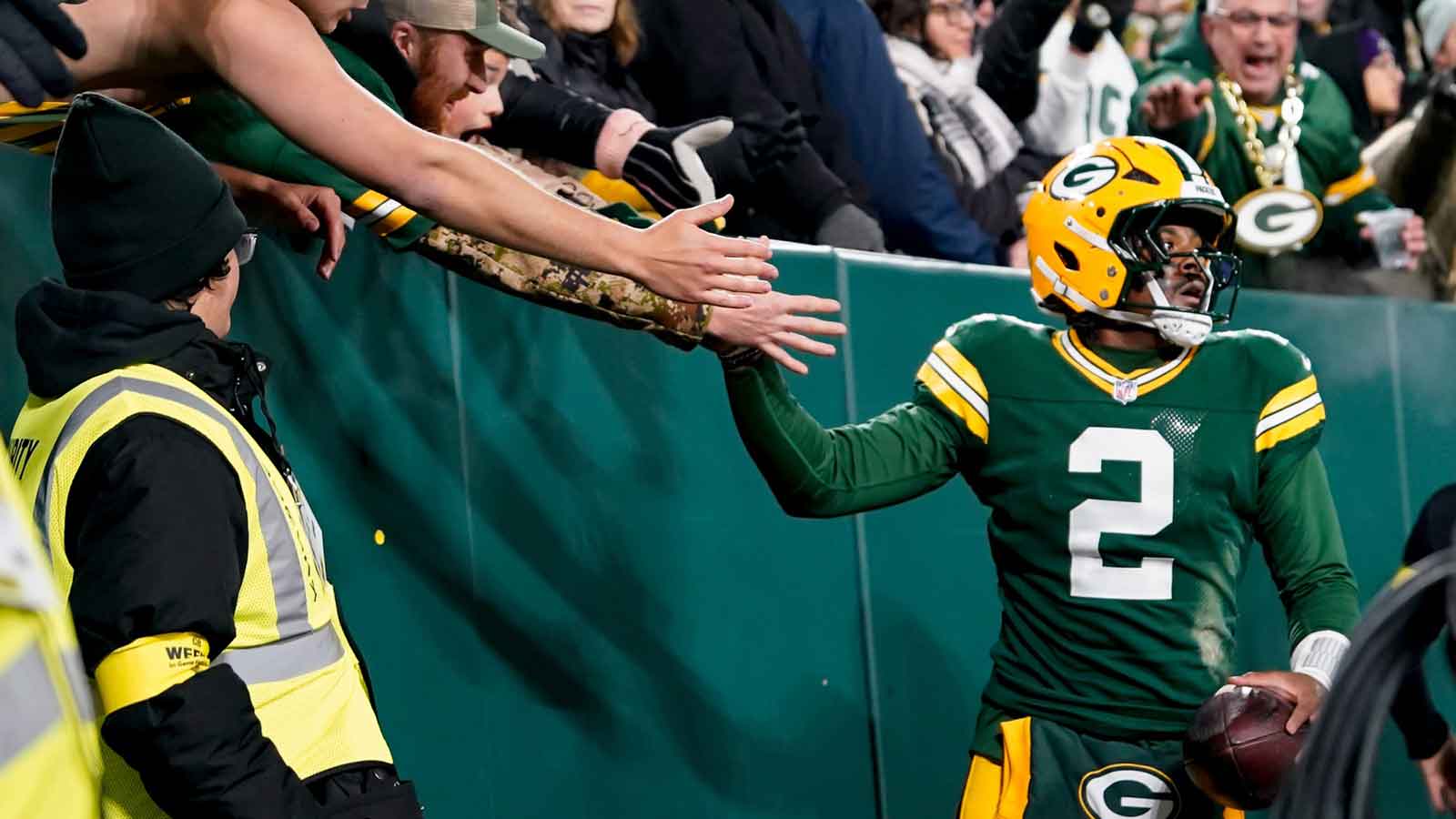 Green Bay Packers quarterback Malik Willis (2) high-fives fans after a touchdown during the third quarter against the Baltimore Ravens at Lambeau Field.