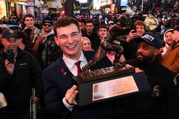 Indiana quarterback Fernando Mendoza celebrates in Times Square after winning the Heisman Trophy in New York on Dec. 13. (Todd Van Emst The Associated Press)