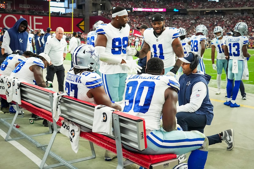 Dallas Cowboys linebacker Micah Parsons (11) talks with defensive line coach Aden Durde...