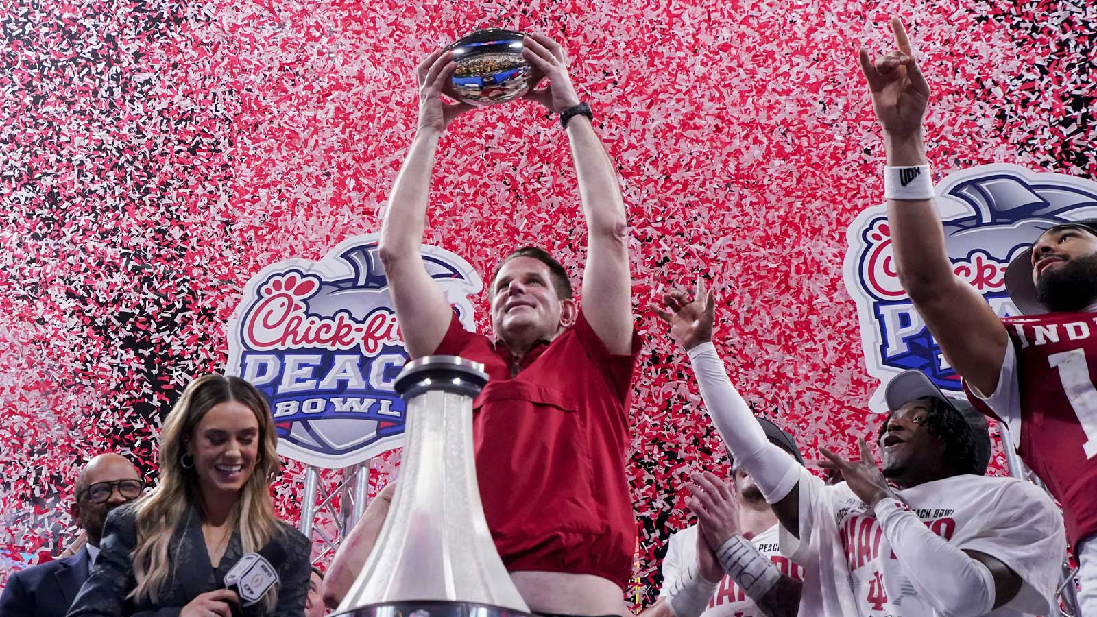 Indiana Hoosiers head coach Curt Cignetti holds up the trophy as confetti falls Friday, Jan. 9, 2026, after defeating the Oregon Ducks in the Peach Bowl and semifinal game of the College Football Playoff at Mercedes-Benz Stadium in Atlanta.
