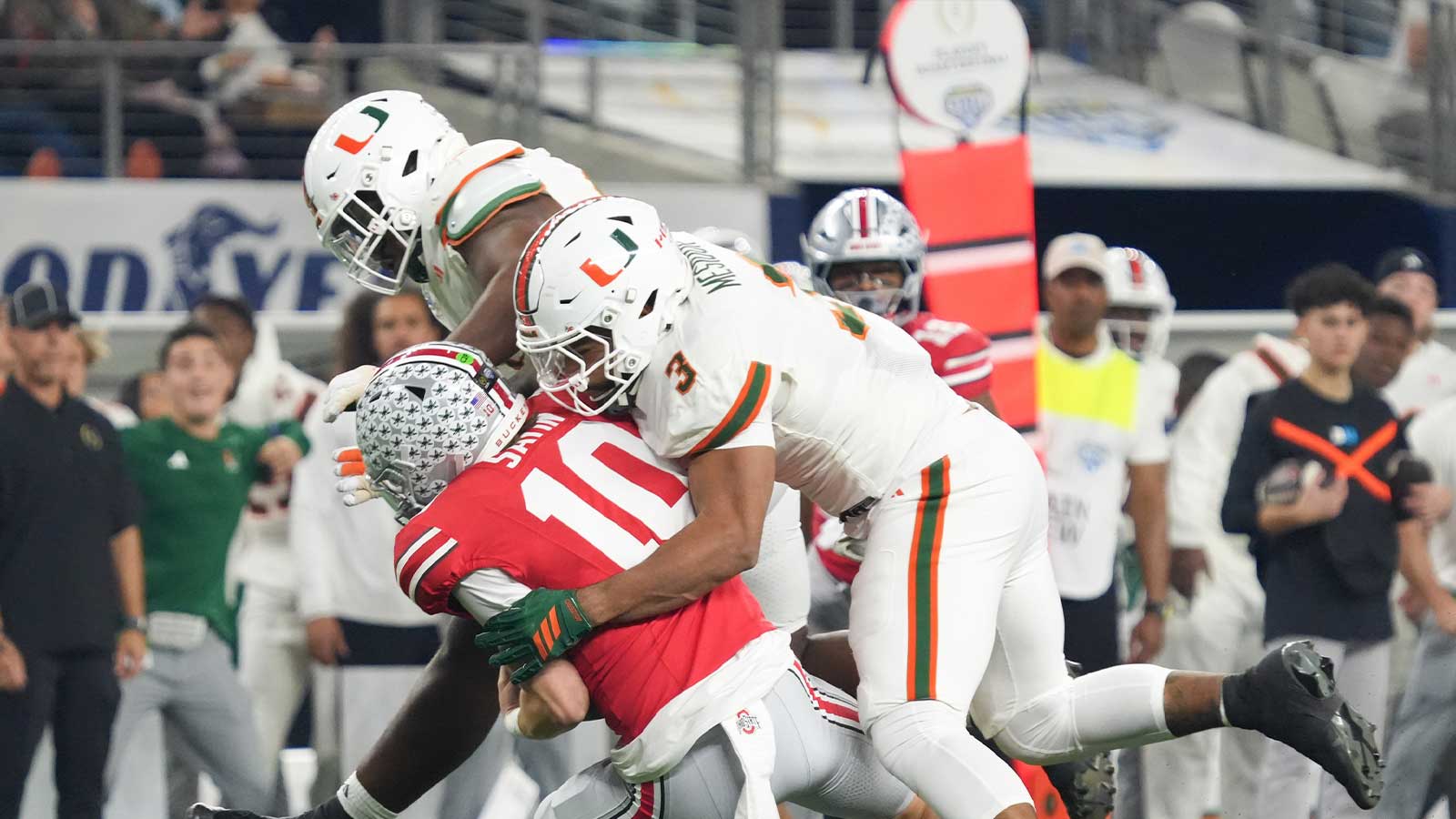 Ohio State Buckeyes quarterback Julian Sayin (10) is sacked by Miami Hurricanes defensive lineman Akheem Mesidor (3) in the first quarter during the 2025 Cotton Bowl and quarterfinal game of the College Football Playoff at AT&T Stadium.