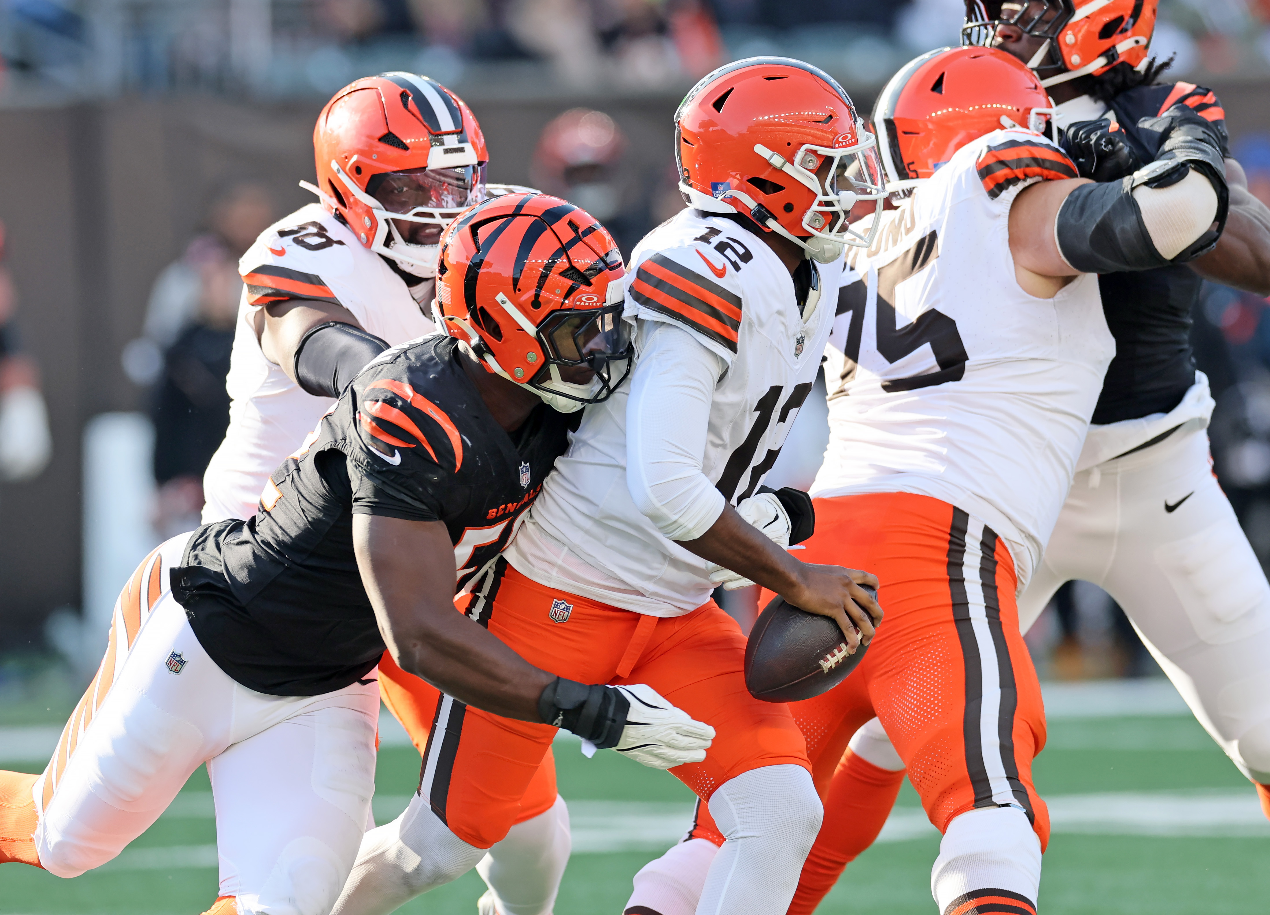 Cincinnati Bengals defensive end Cedric Johnson hits Cleveland Browns quarterback Shedeur Sanders, but Sanders manages to get the pass away in the first half of play. 