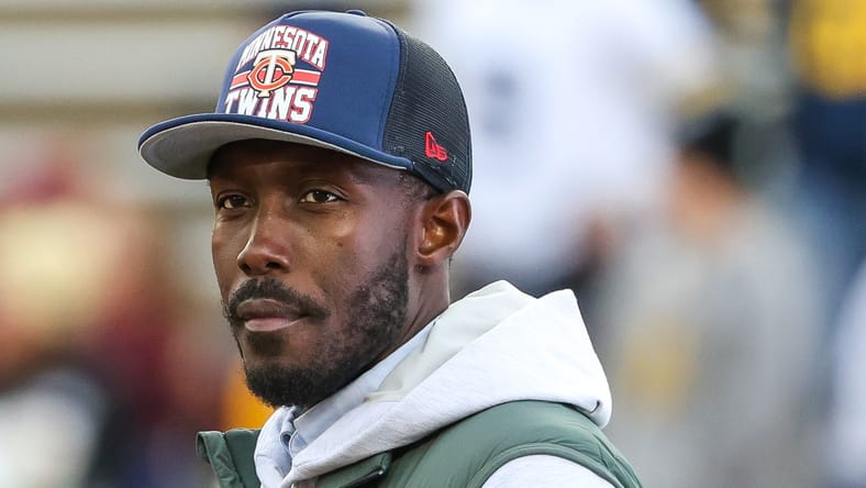 Kwesi Adofo-Mensah watches a college football game from the sideline. vikings offseason surprises 2026