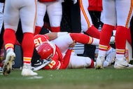 FILE - Kansas City Chiefs quarterback Patrick Mahomes (15) clutches his left knee after...