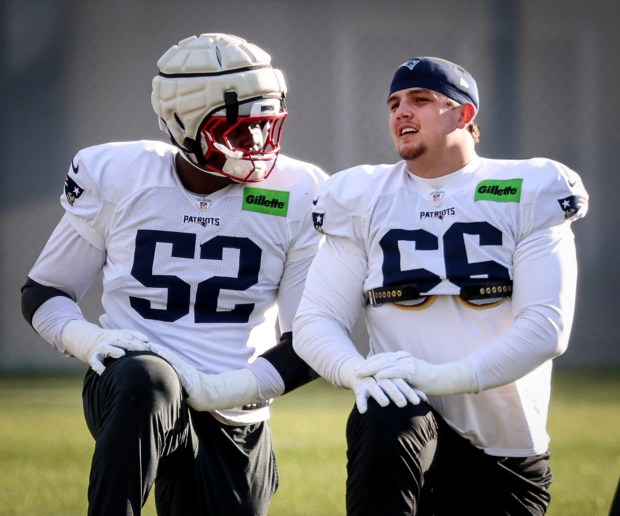 New England Patriots tackles Marcus Bryant (52) and Will Campbell  talk during the stretching portion of a team practice earlier this season in Foxboro. (Mark Stockwell/Boston Herald)