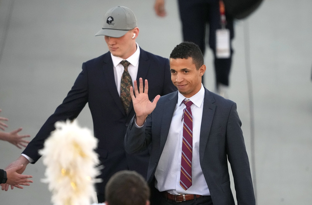 Iowa State offensive coordinator Nate Scheelhaase, right, waves as he arrives at Jack Trice Stadium before an NCAA college football game against Texas, Saturday, Nov. 18, 2023, in Ames, Iowa. 