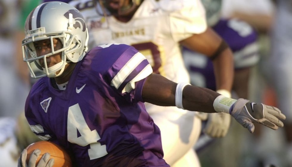 Kansas State punt returner Terence Newman (4) outruns Louisiana-Monroe defender Shaune Maynard...