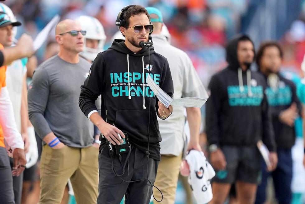 Miami Dolphins head coach Mike McDaniel, center, looks on during the first half of an NFL...