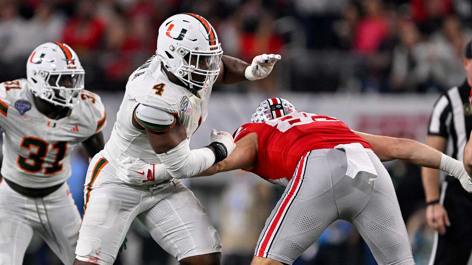 Miami Hurricanes defensive lineman Rueben Bain Jr. (4) rushes the line during the 2025 Cotton Bowl and quarterfinal game of the College Football Playoff at AT&T Stadium.