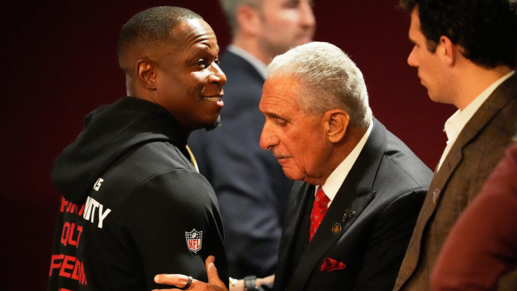 Atlanta Falcons owner Arthur Blank, right, hugs head coach Raheem Morris after an NFL football game against the New Orleans Saints, Sunday, Jan. 4, 2026, in Atlanta.
