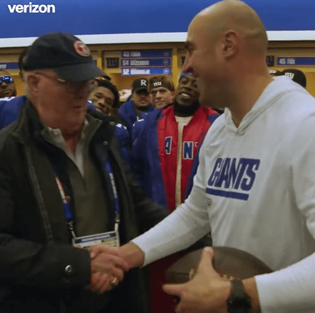 Giants co-owner John Mara gets a game ball from interim coach Mike Kafka on Sunday.