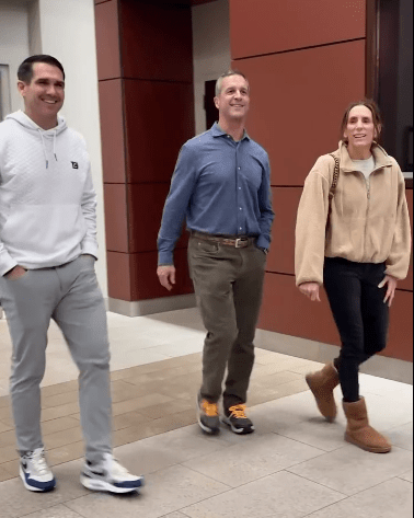 Joe Schoen, John Harbaugh and Ingrid Harbaugh walking into the Giants facility on Monday.