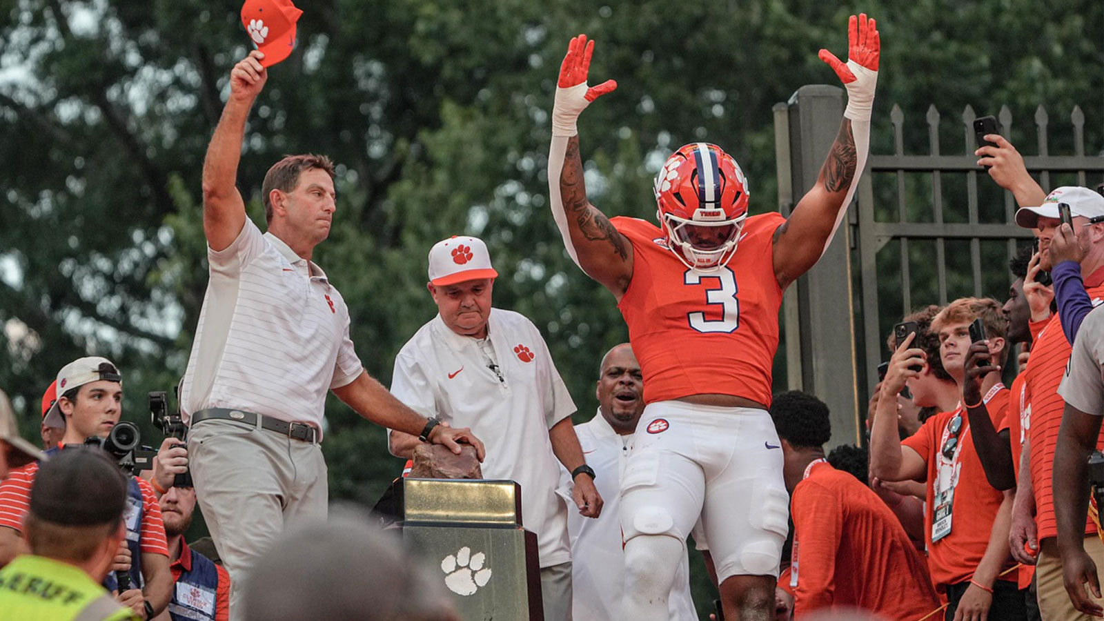 Clemson head coach Dabo Swinney rubs Howard’s Rock near Clemson defensive end T.J. Parker (3) before the game with Clemson and Louisiana State University at Memorial Stadium in Clemson, S.C. Saturday, August 30, 2025.