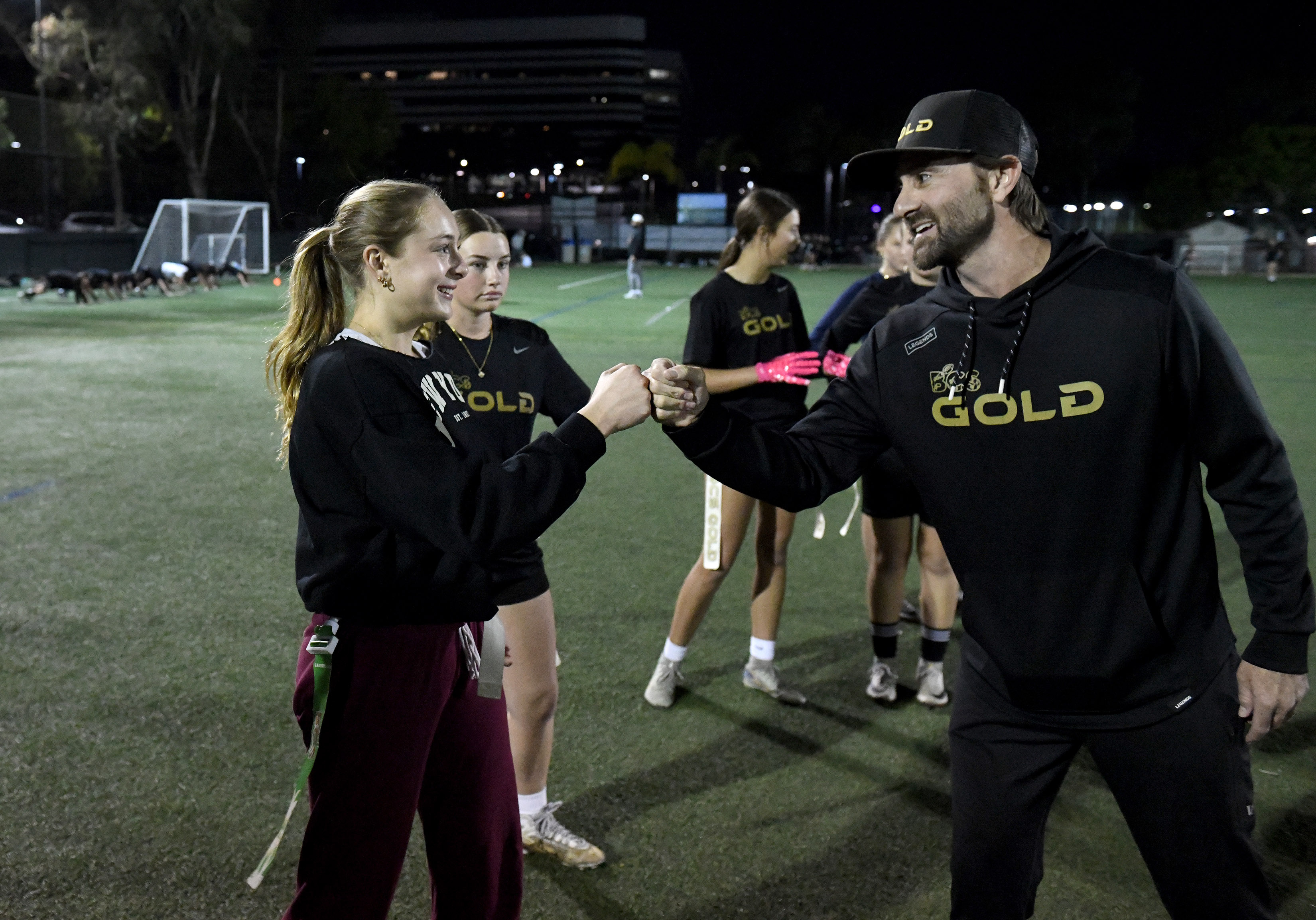 BCS Gold club flag football coach Steve Rivera greets Marley...