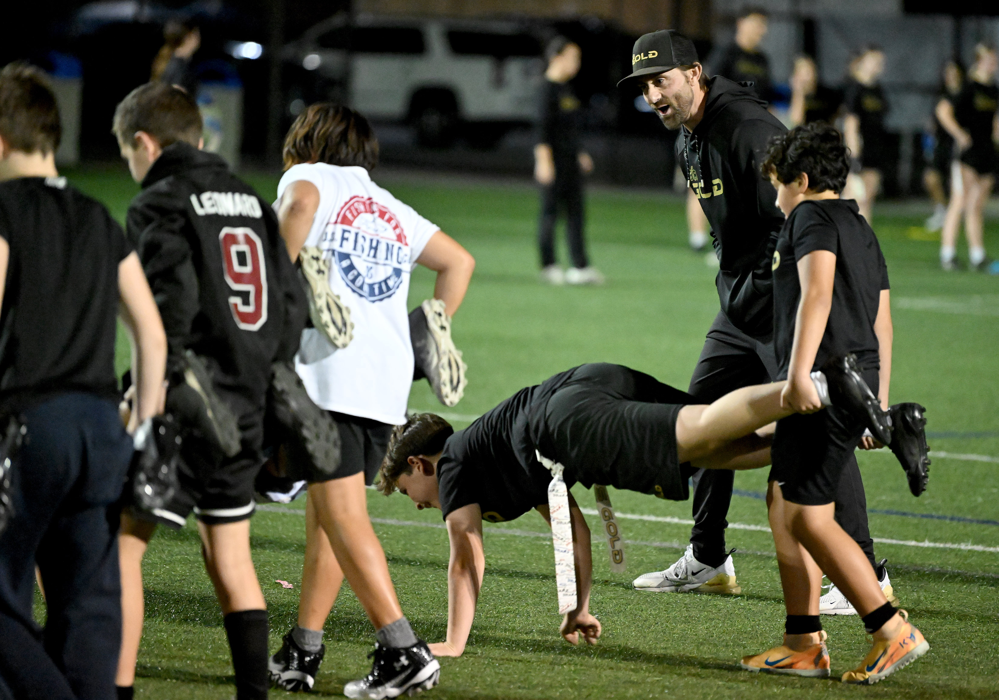 South Bay flag football coach Steve Rivera cheers on a...