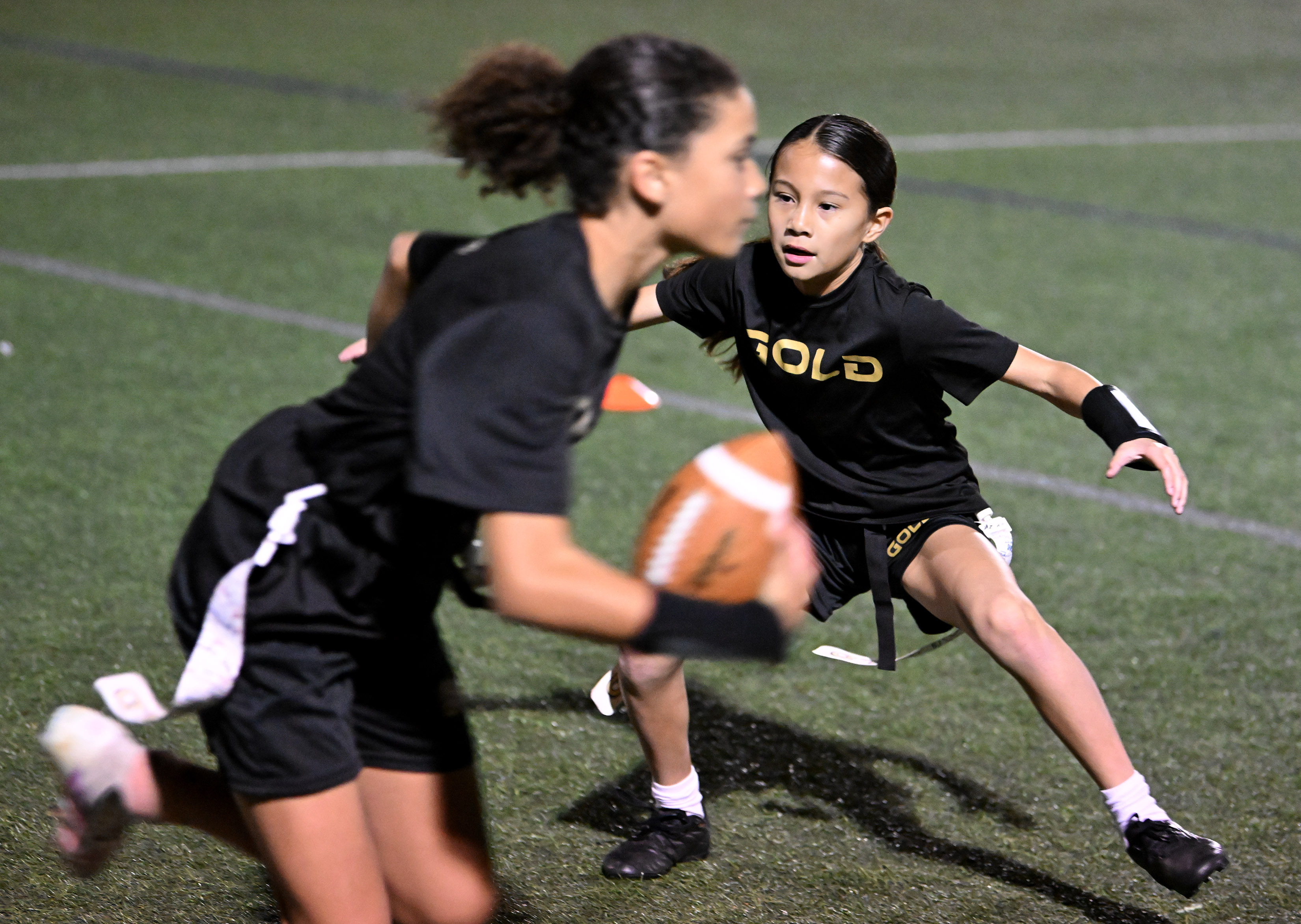 Naomi Paul, 10, defends against ball carrier Zoe Yoswa in...