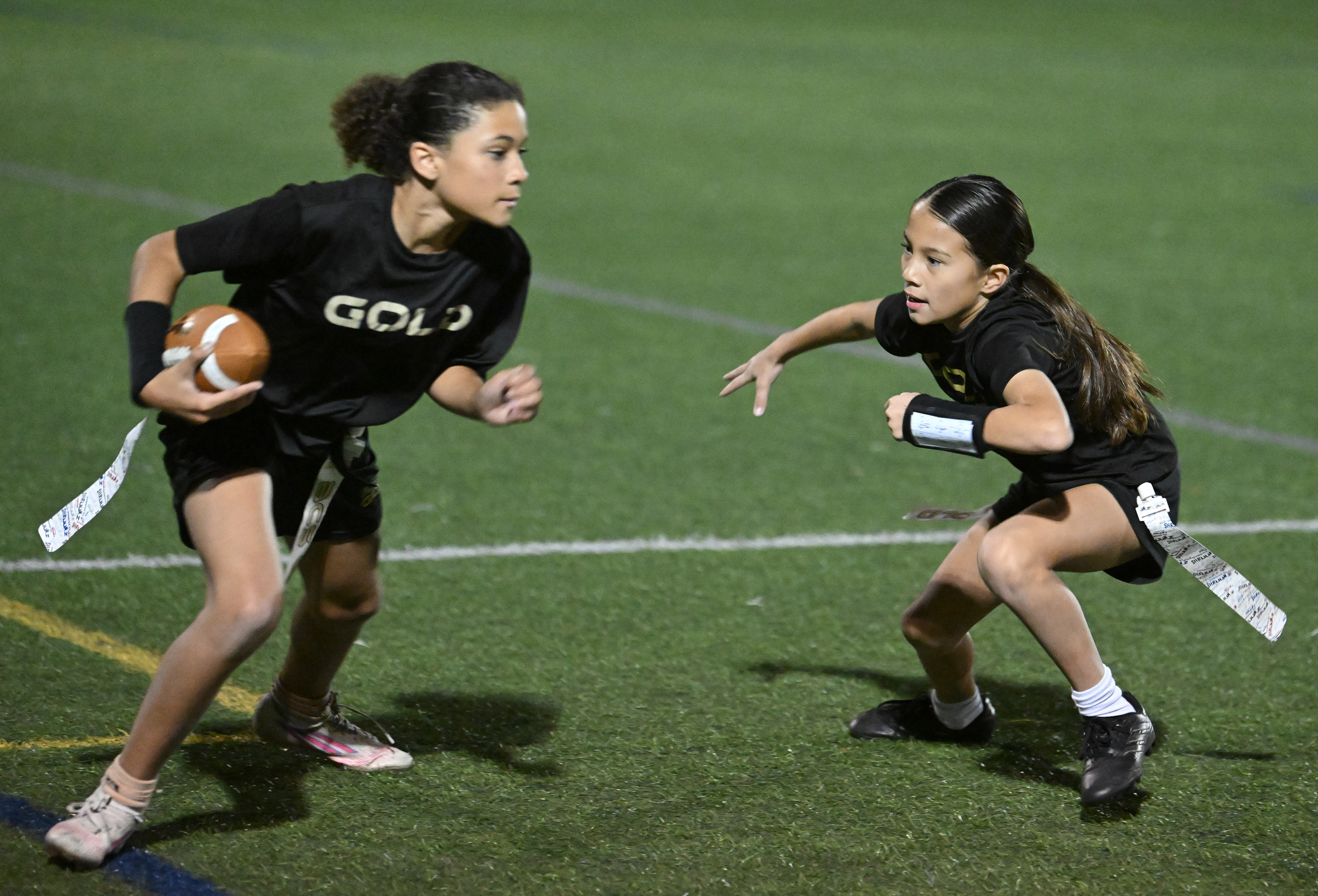 Naomi Paul, 10, defends against ball carrier Zoe Yoswa in...
