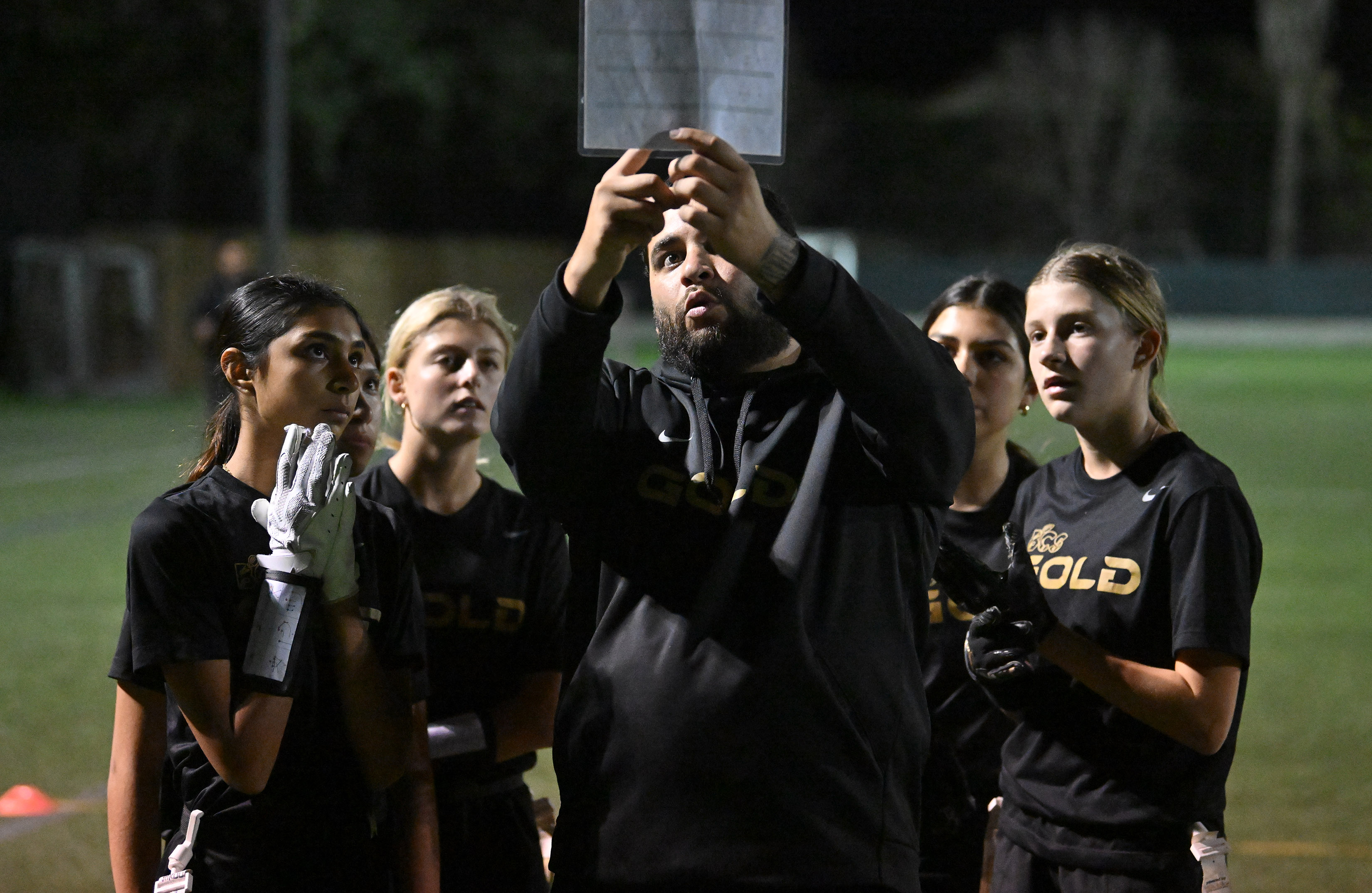 Coach Kevin Garcia runs the play with his 13U BCS...