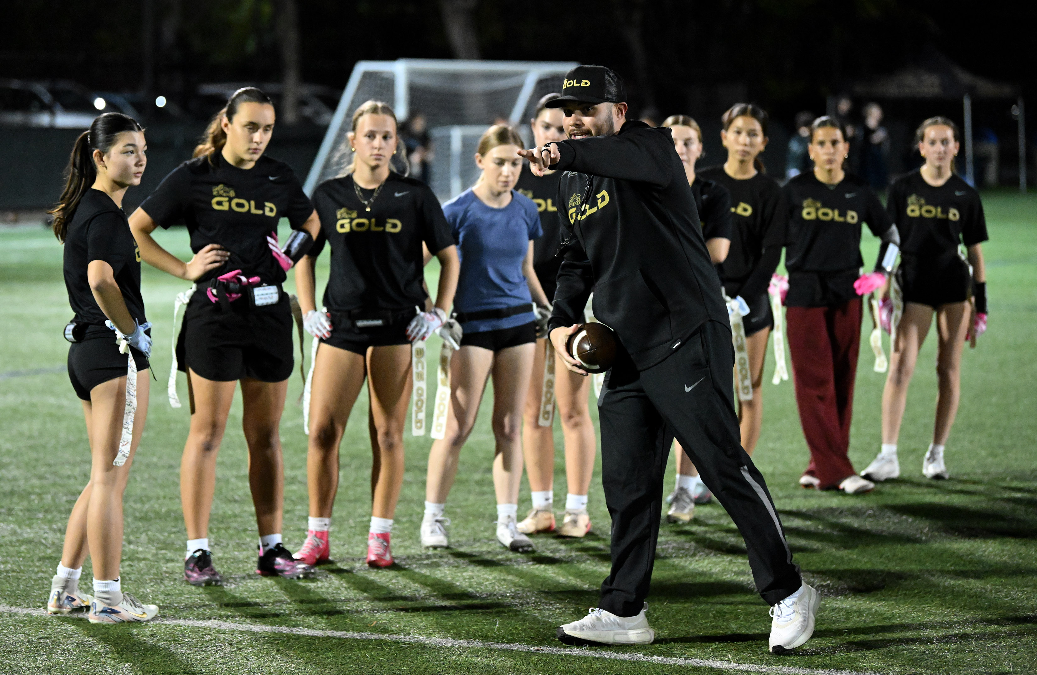 BCS Gold club coach Jake Jimenez leads a drill for...