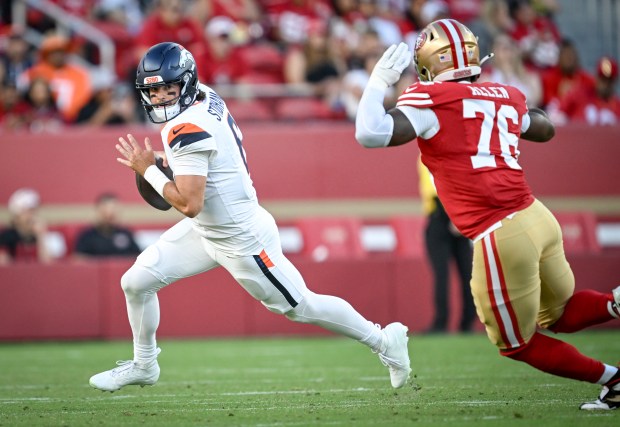Jarrett Stidham (8) of the Denver Broncos rolls out as Jaylon Allen (76) of the San Francisco 49ers pressures during the third quarter at Levi's Stadium in Santa Clara, California on Saturday, Aug. 9, 2025. (Photo by AAron Ontiveroz/The Denver Post)