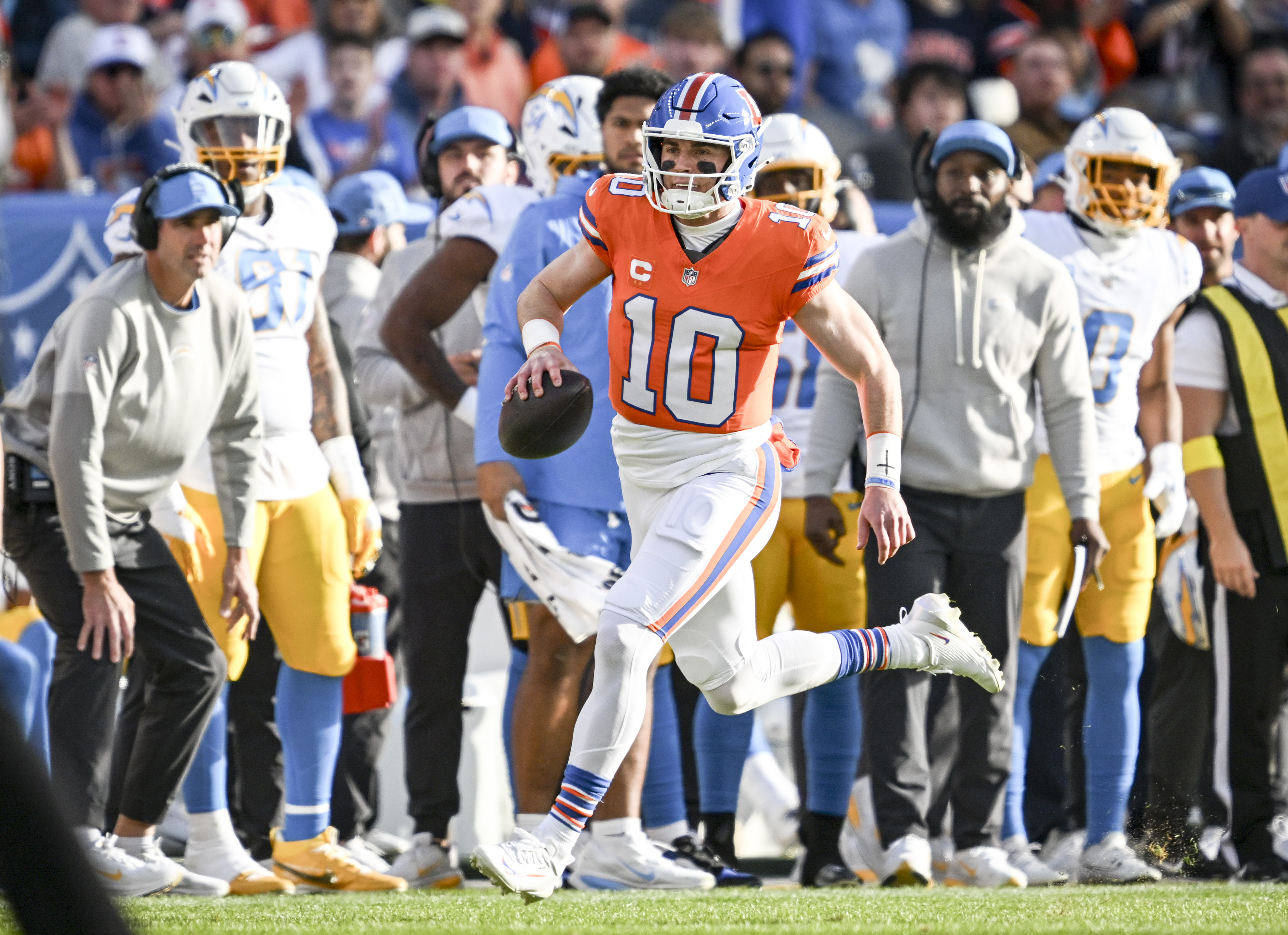 Bo Nix (10) of the Denver Broncos runs for a...