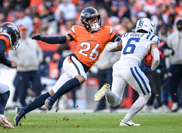 Devon Key (26) of the Denver Broncos whiffs as Anthony Gould (6) of the Indianapolis Colts breaks off a big punt return during the second quarter at Empower Field at Mile High in Denver on Sunday, Dec. 15, 2024. (Photo by AAron Ontiveroz/The Denver Post)