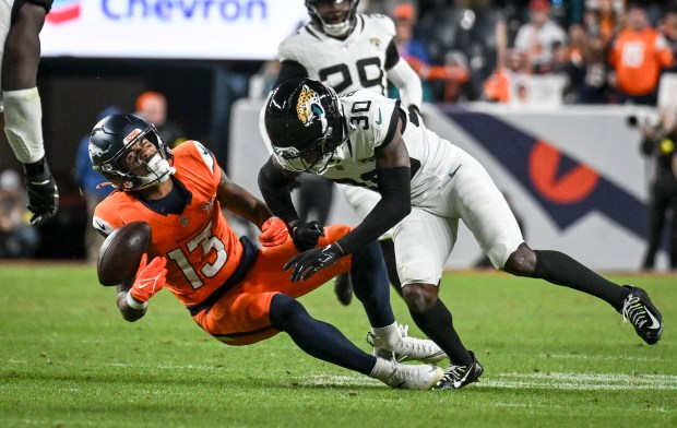 Montaric Brown (30) of the Jacksonville Jaguars blows up Pat Bryant (13) of the Denver Broncos during the fourth quarter of the Jaguars' 34-20 win at Empower Field at Mile High in Denver on Sunday, Dec. 21, 2025. Bryant would leave the field on a cart as a result of the play. (Photo by AAron Ontiveroz/The Denver Post)