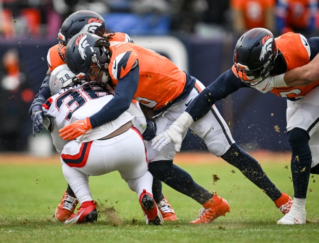 DENVER , CO - JANUARY 25: P.J. Locke (6) of the Denver Broncos tackles Rhamondre Stevenson (38) of the New England Patriots during the first quarter at Empower Field at Mile High in Denver, Colorado on Sunday, January 25, 2026. (Photo by AAron Ontiveroz/The Denver Post)