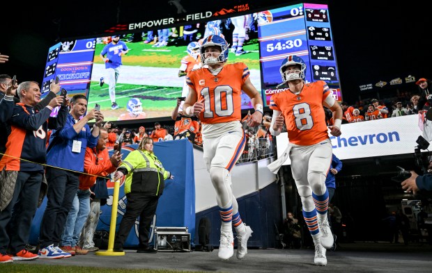 Bo Nix (10) and Jarrett Stidham (8) of the Denver Broncos take the field before the game against the Las Vegas Raiders Empower Field at Mile High Stadium on Thursday, Nov. 6, 2025. (Photo by AAron Ontiveroz/The Denver Post)