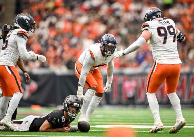 Jonathon Cooper (0) of the Denver Broncos celebrates sacking Davis Mills (10) of the Houston Texans with Zach Allen (99) of the Denver Broncosduring the second quarter at NRG Stadium in Houston, Texas on Sunday, Nov. 2, 2025. (Photo by AAron Ontiveroz/The Denver Post)