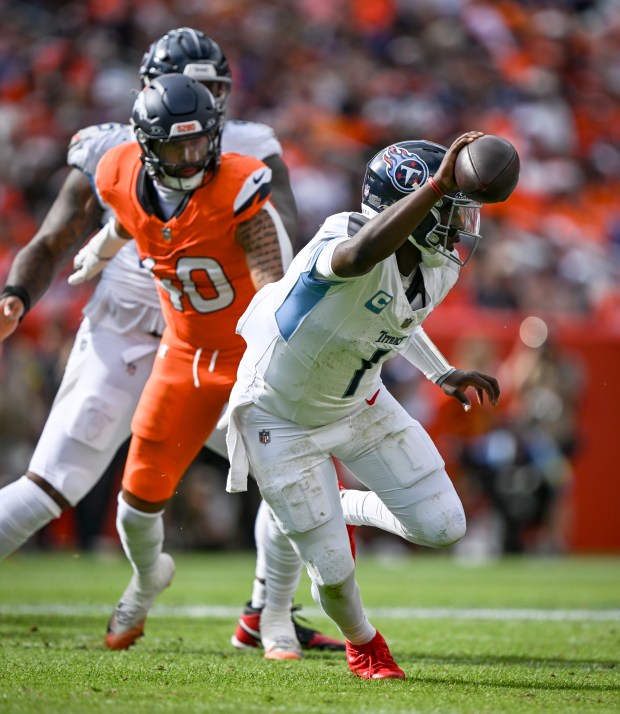Justin Strnad (40) of the Denver Broncos pressures Cam Ward (1) of the Tennessee Titans during the third quarter at Empower Field at Mile High on Sunday, Sept. 7, 2025. (Photo by AAron Ontiveroz/The Denver Post)