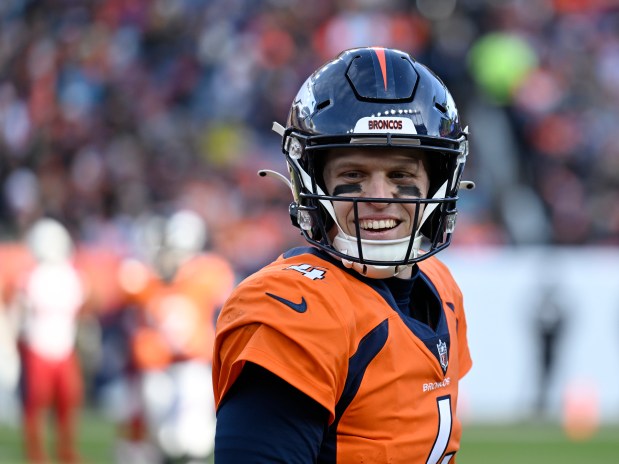 Denver Broncos quarterback Brett Rypien (4) smiles back toward his teammates as the Denver Broncos take on the Arizona Cardinals at Empower Field on Dec. 18, 2022 in Denver.(Photo by RJ Sangosti/The Denver Post)
