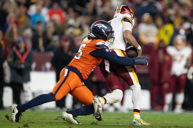 Linebacker Nik Bonitto (15) of the Denver Broncos sacks quarterback Marcus Mariota (8) of the Washington Commanders before Mariota fumbled the ball on an attempted lateral pass on Sunday, Nov. 30, 2025, at Northwest Stadium in Landover, MD. (Photo by Timothy Hurst/The Denver Post)