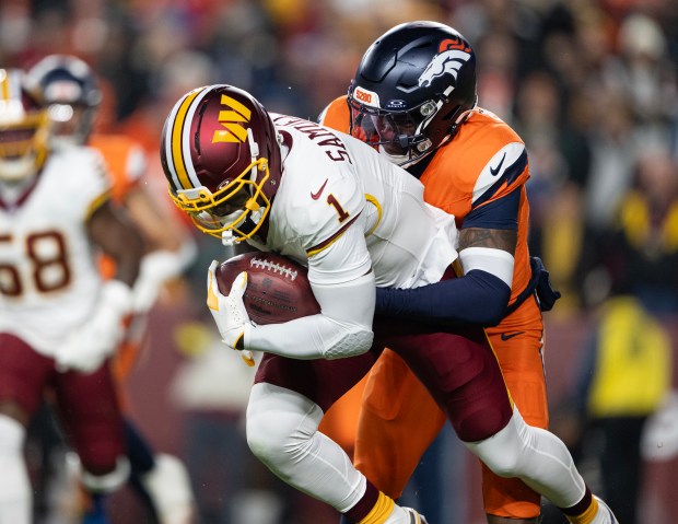 Safety JL Skinner (34) of the Denver Broncos tackles wide receiver Deebo Samuel (1) of the Washington Commanders during a kick return on Sunday, Nov. 30, 2025, at Northwest Stadium in Landover, MD. (Photo by Timothy Hurst/The Denver Post)